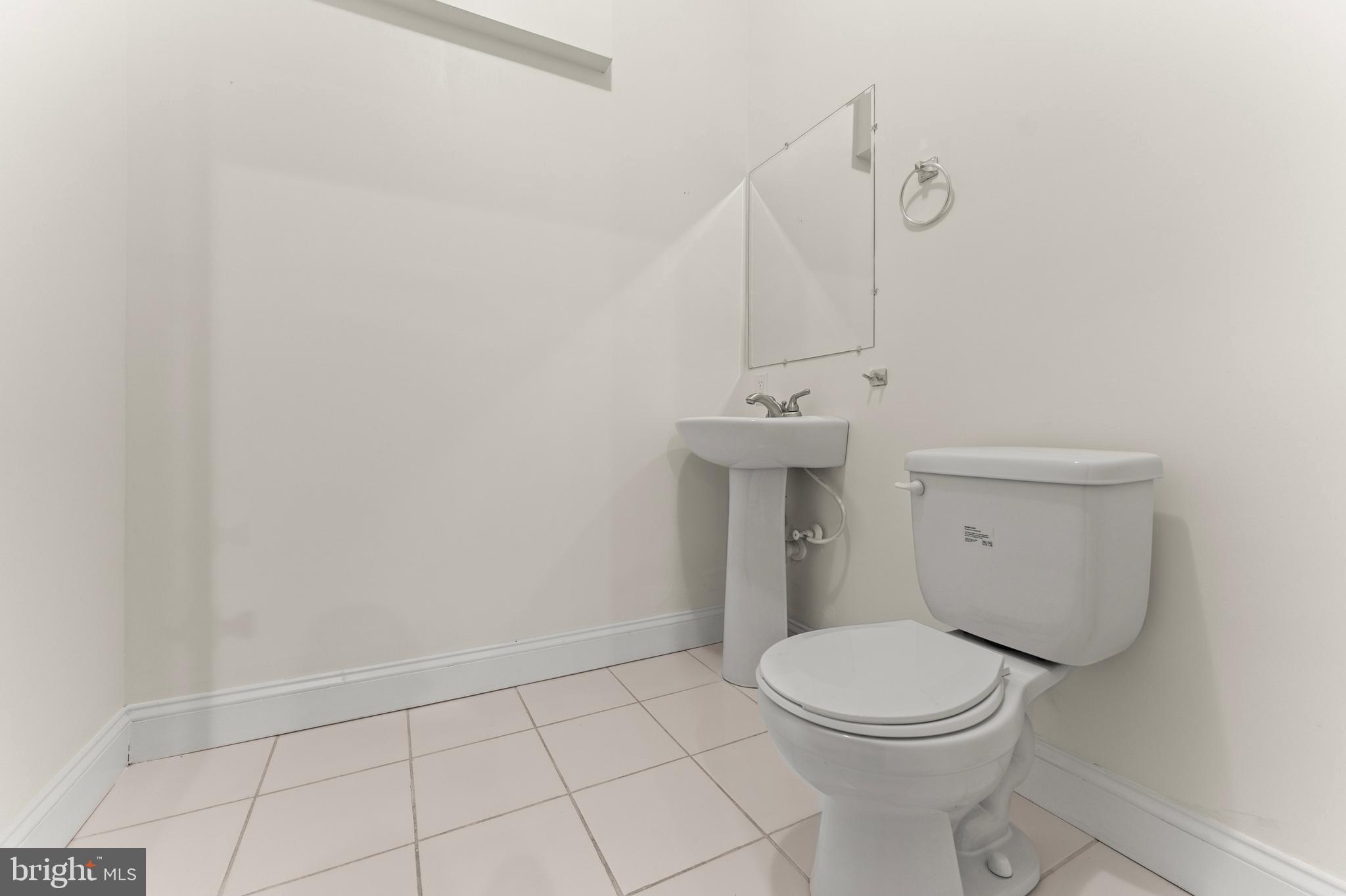3616 Reisterstown Road Baltimore, MD 21215 - Photo 29 of 34 a bathroom with a toilet