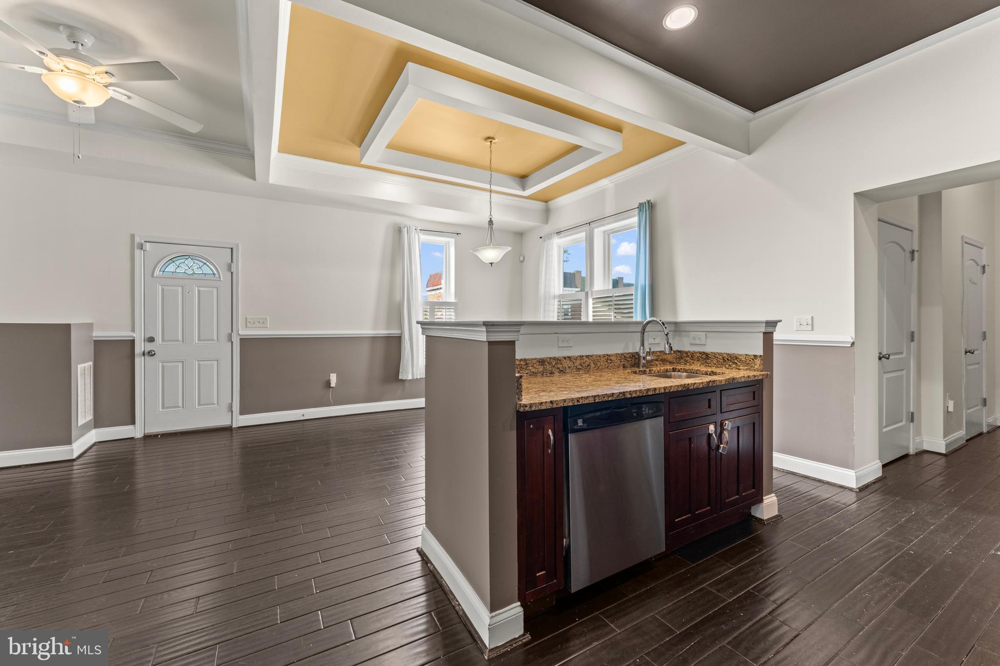 3616 Reisterstown Road Baltimore, MD 21215 - Photo 7 of 34 a kitchen with stainless steel appliances granite countertop a sink and wooden floors