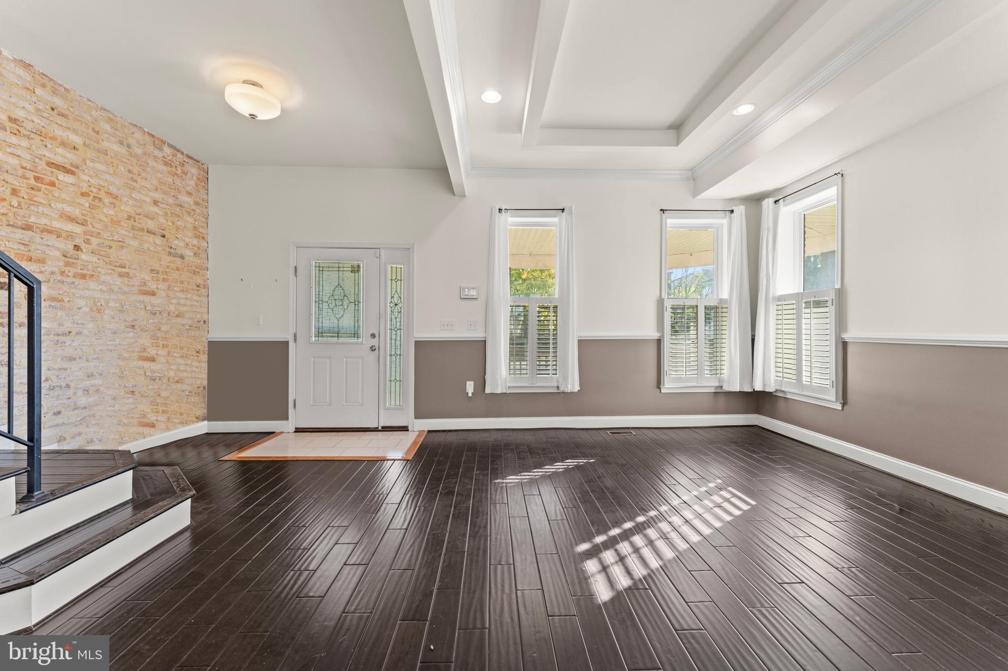 3616 Reisterstown Road Baltimore, MD 21215 - Photo 10 of 34 a view of an empty room with wooden floor and a window