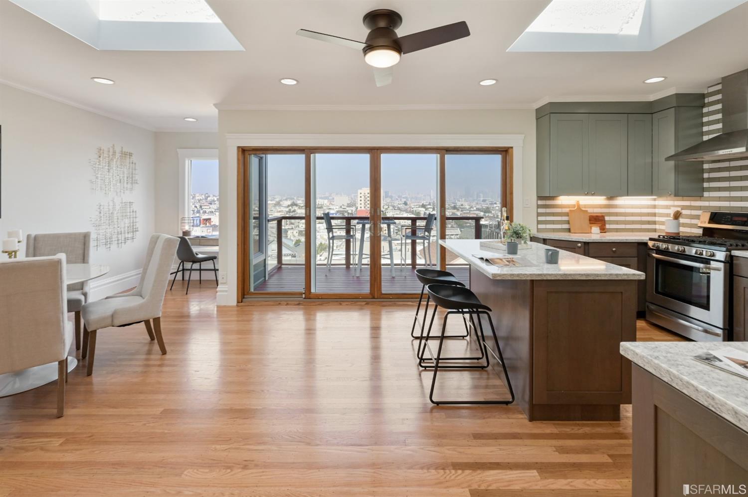 41 Montezuma Street San Francisco, CA 94110 - Photo 12 of 62 a kitchen with stainless steel appliances granite countertop a stove oven a dining table and chairs with wooden floor