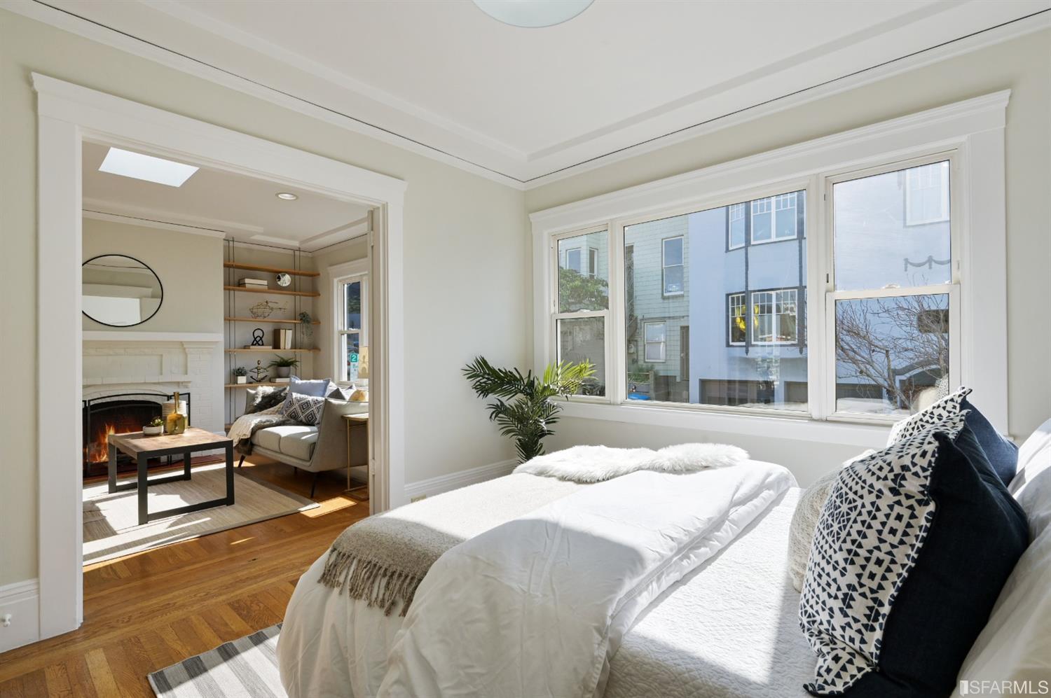 41 Montezuma Street San Francisco, CA 94110 - Photo 29 of 62 a bedroom with a bed and wooden floor