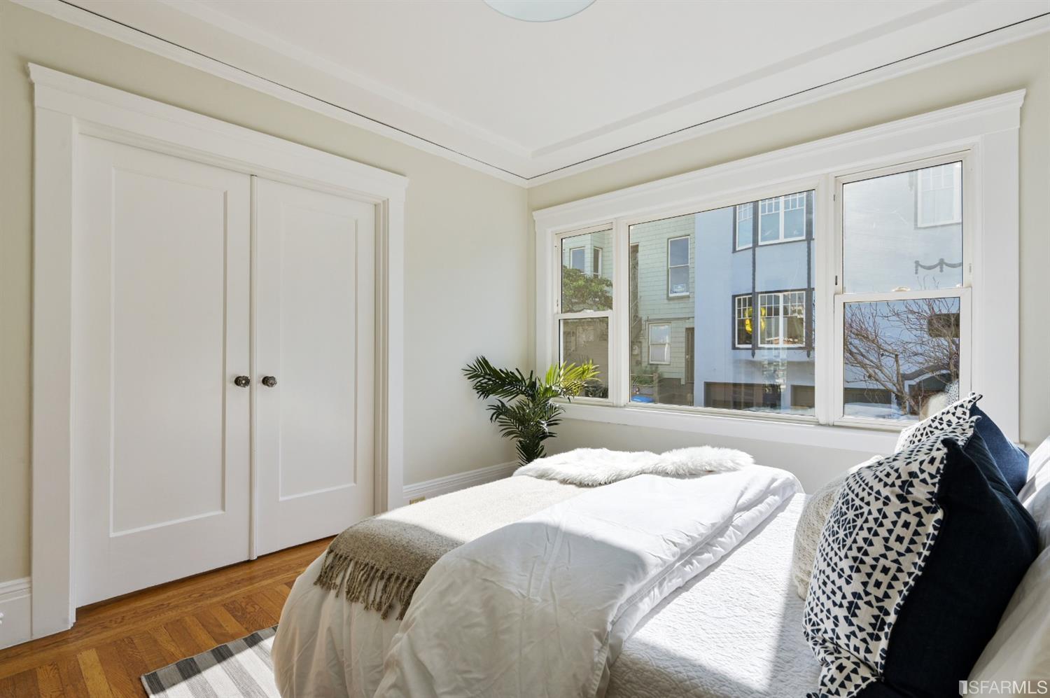 41 Montezuma Street San Francisco, CA 94110 - Photo 30 of 62 a bedroom with a bed and a large window