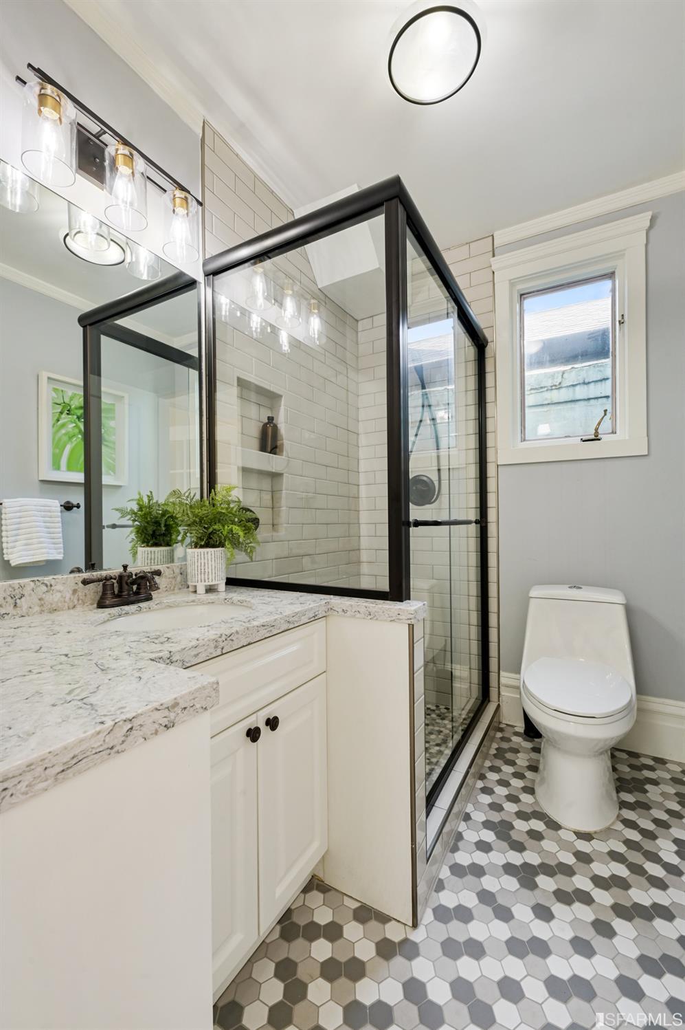 41 Montezuma Street San Francisco, CA 94110 - Photo 33 of 62 a bathroom with a granite countertop sink mirror vanity and toilet