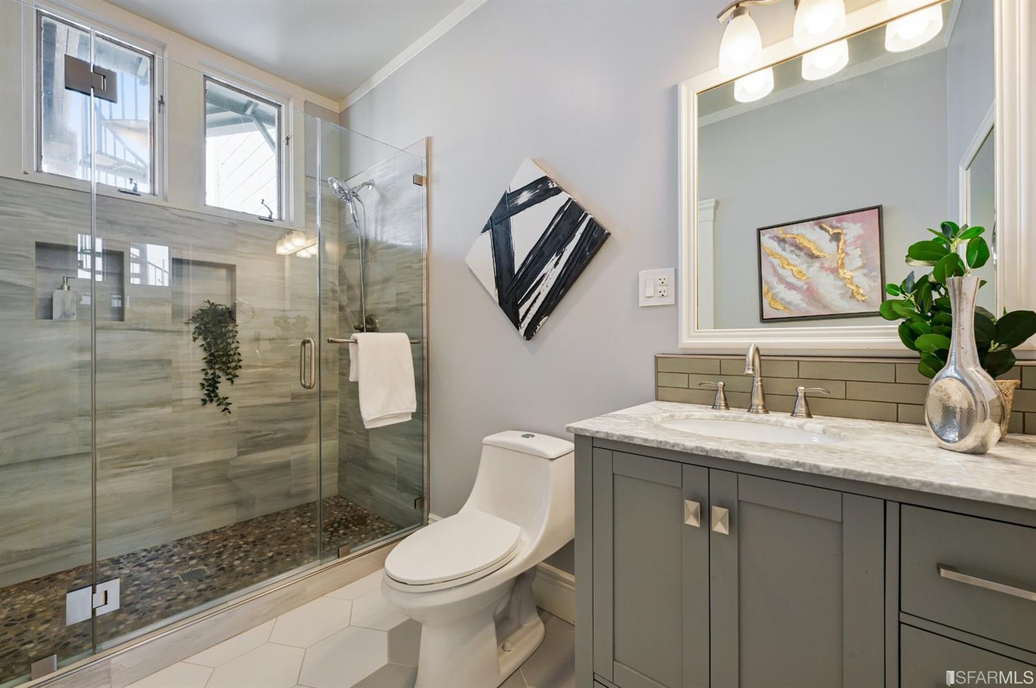 41 Montezuma Street San Francisco, CA 94110 - Photo 41 of 62 a bathroom with a granite countertop sink a toilet and a shower