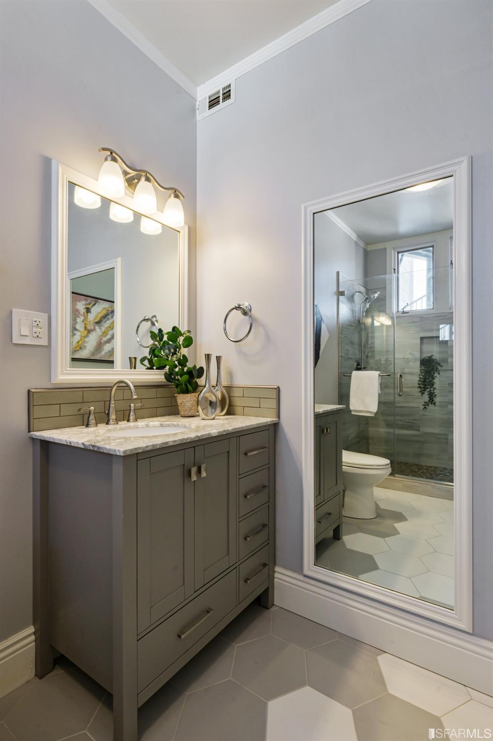 41 Montezuma Street San Francisco, CA 94110 - Photo 42 of 62 a bathroom with a double vanity sink and mirror with shower