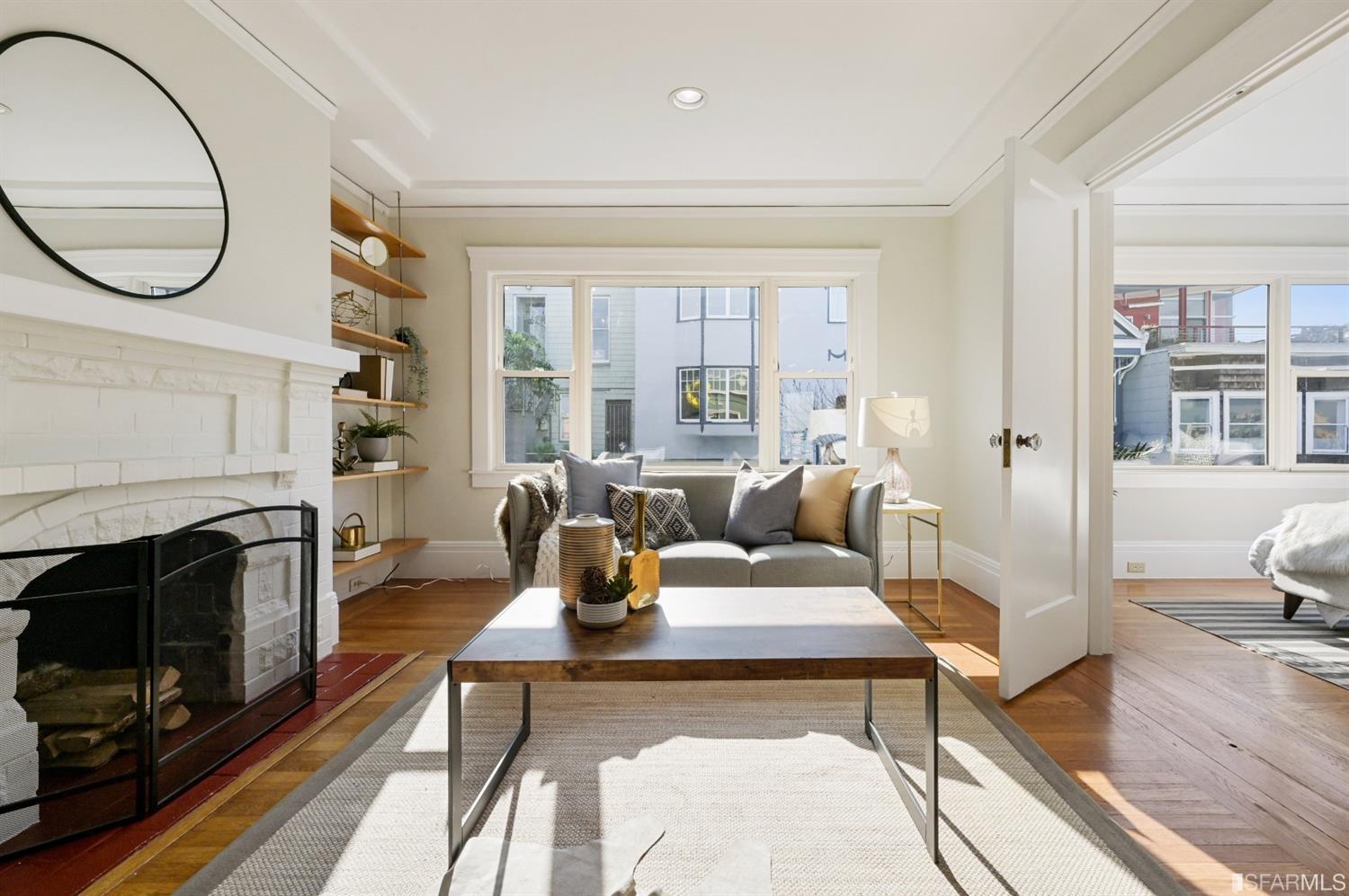 41 Montezuma Street San Francisco, CA 94110 - Photo 5 of 62 a living room with furniture a fireplace and a floor to ceiling window