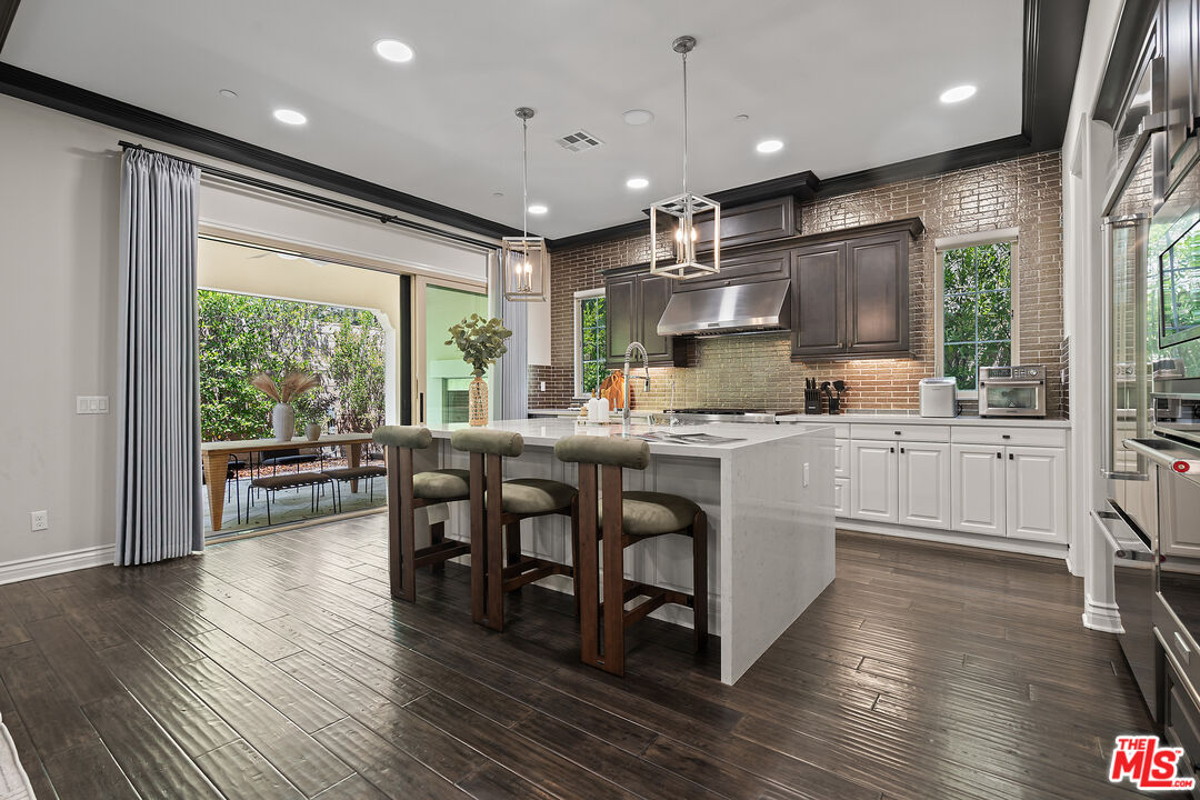 55 Suede Irvine, CA 92602 - Photo 15 of 59 a kitchen with counter top space a sink appliances and living room view