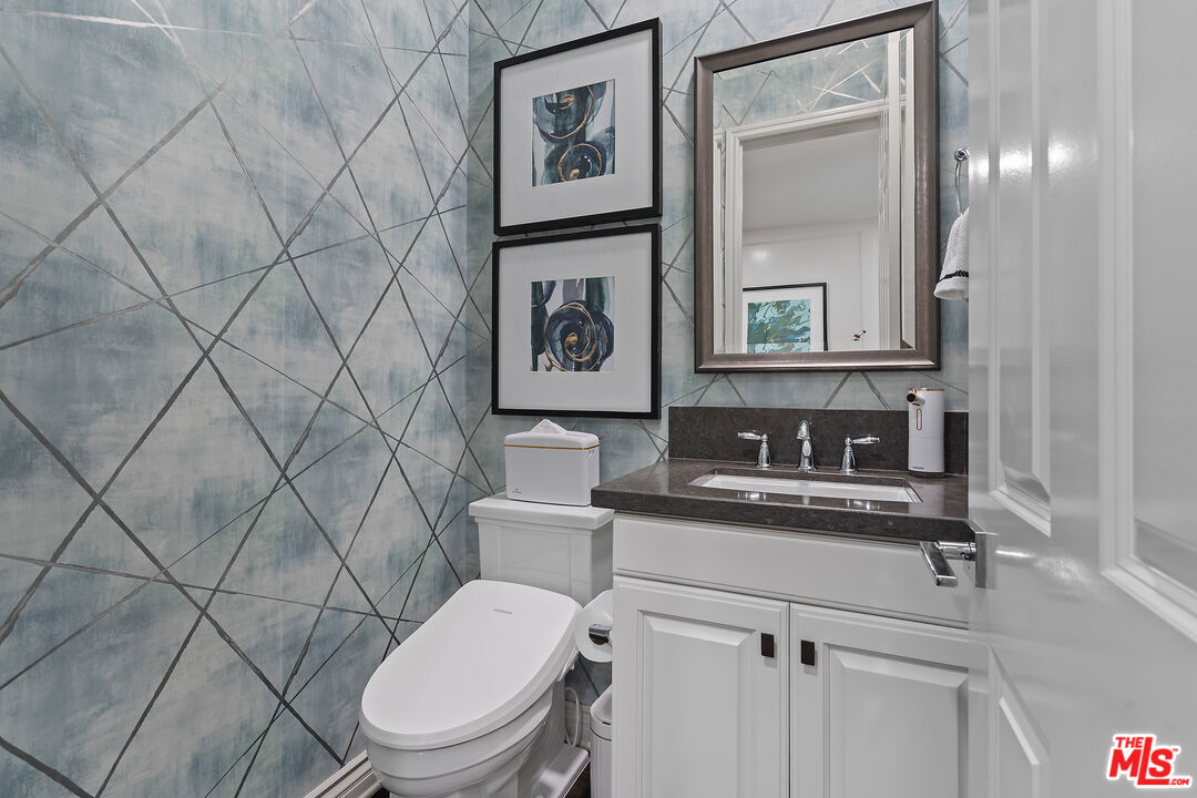 55 Suede Irvine, CA 92602 - Photo 22 of 59 a bathroom with a toilet sink and mirror
