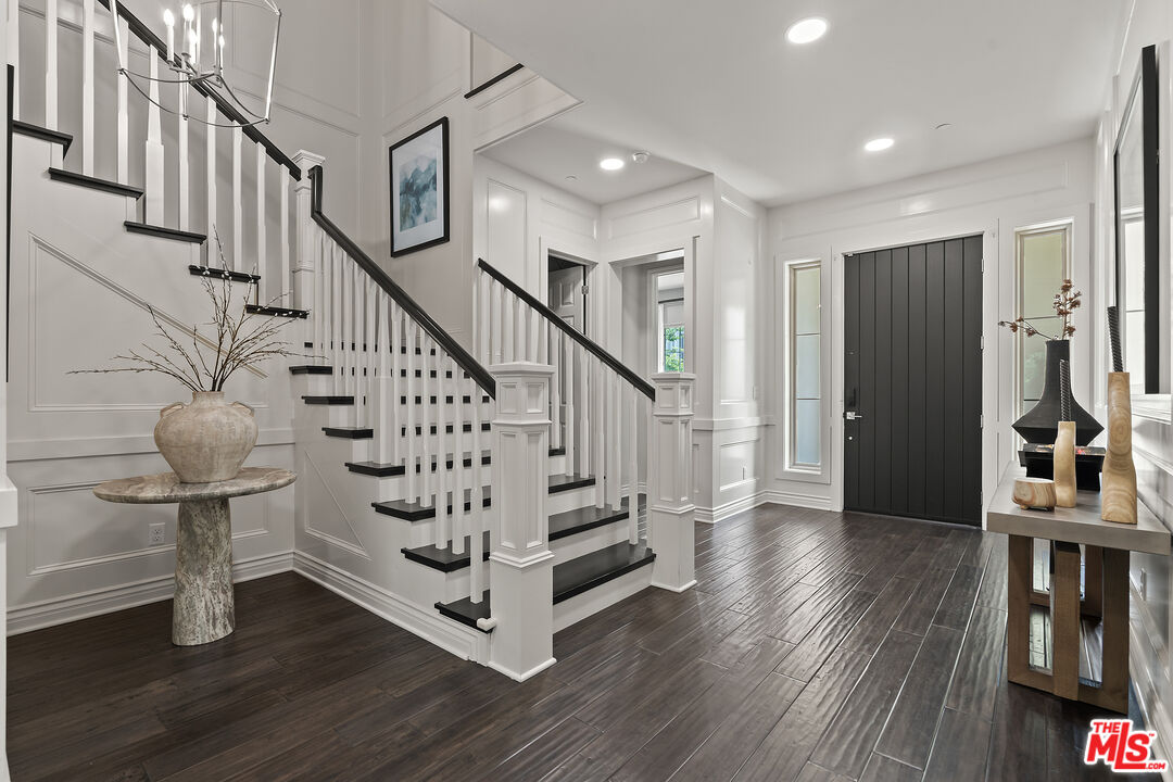 55 Suede Irvine, CA 92602 - Photo 23 of 59 a view of entryway with wooden floor and stairs