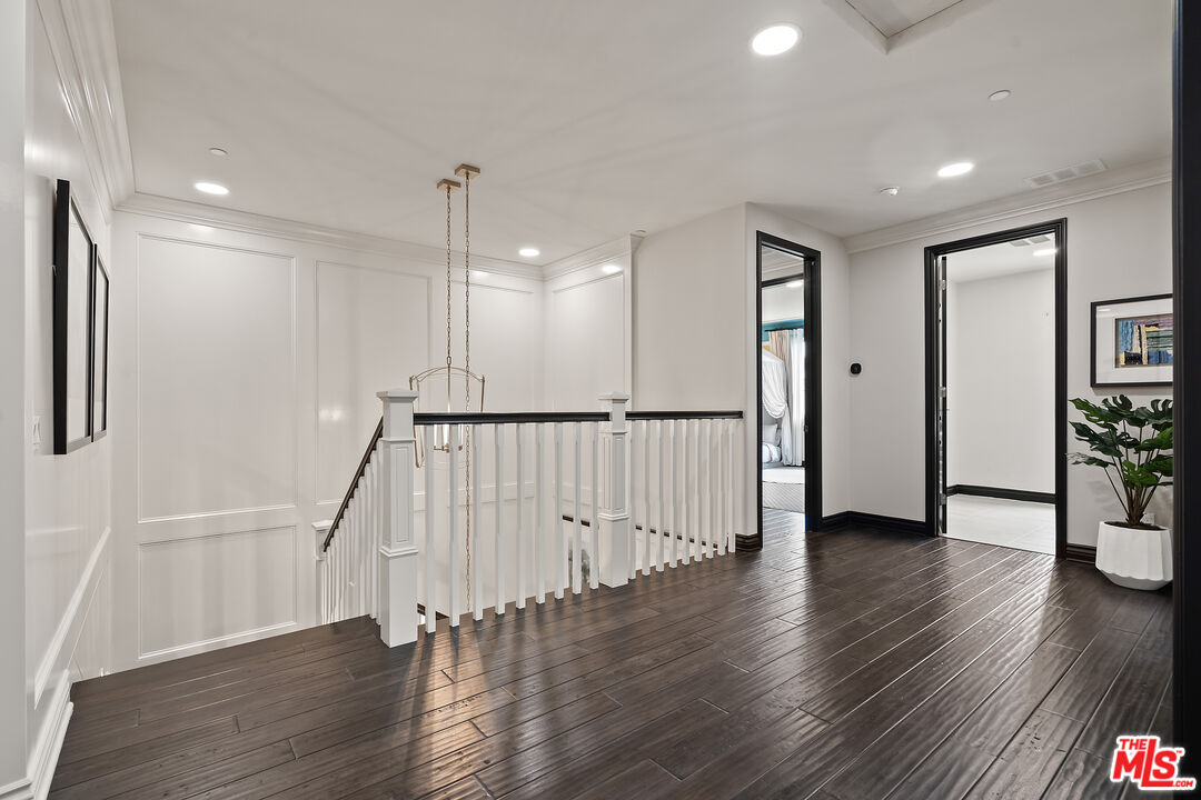 55 Suede Irvine, CA 92602 - Photo 29 of 59 a view of a hallway with wooden floor and stairs