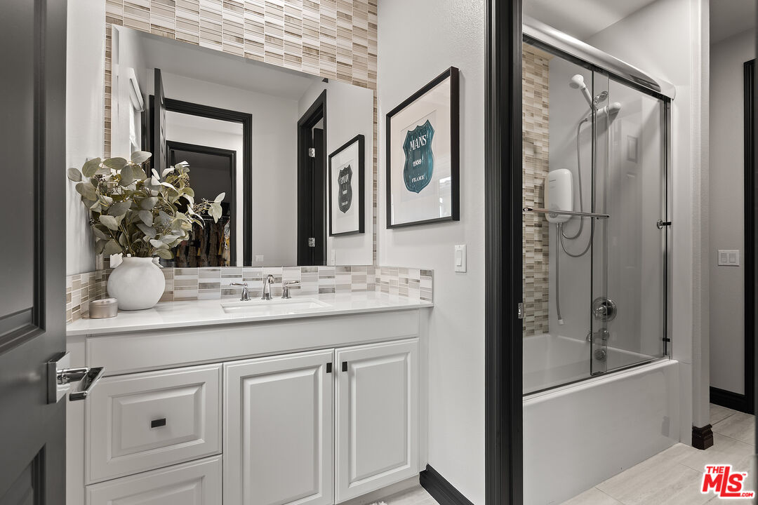 55 Suede Irvine, CA 92602 - Photo 41 of 59 a bathroom with a granite countertop sink vanity mirror and shower