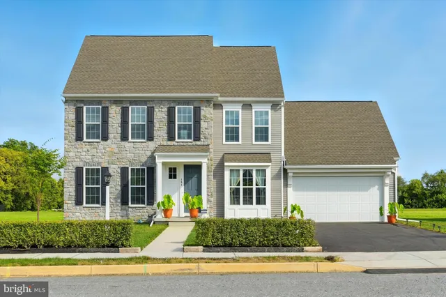 a front view of a house with a yard and outdoor seating