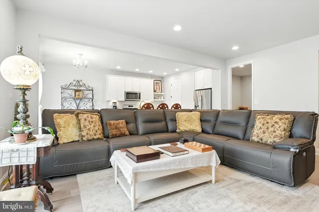 a living room with furniture and a chandelier