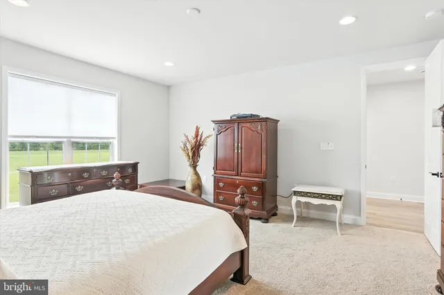 a bedroom with a bed a table and chair