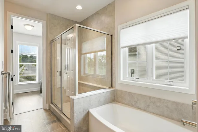 a bathroom with a bathtub and a shower