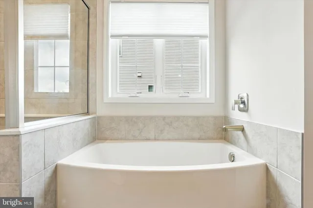 a white bath tub sitting next to a window