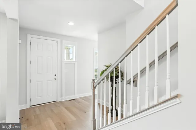 a view of an entryway with wooden floor