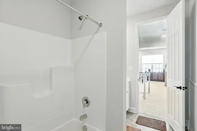 a bathroom with a glass shower door