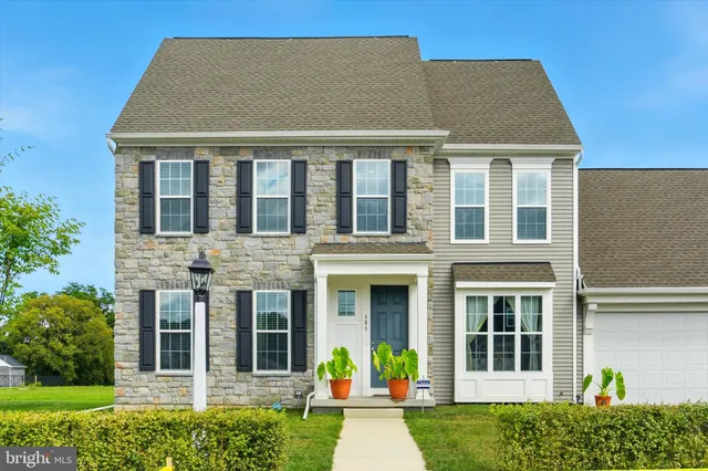 a front view of a residential apartment building with a yard