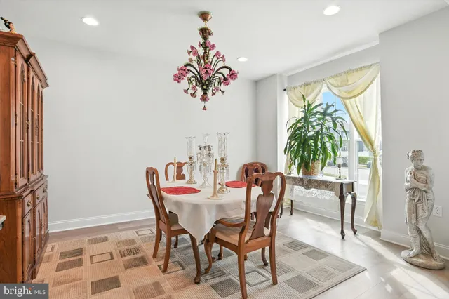 a view of a dining room with furniture and a potted plant