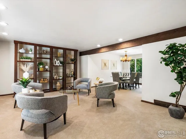 a living room with furniture and potted plant