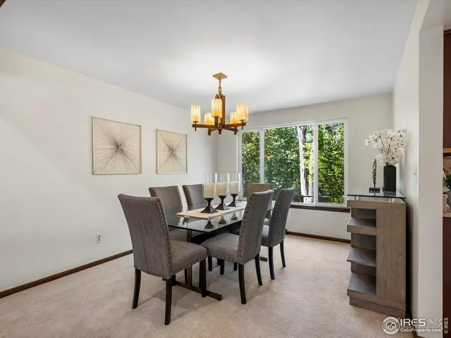 a dining room with furniture a chandelier and a rug
