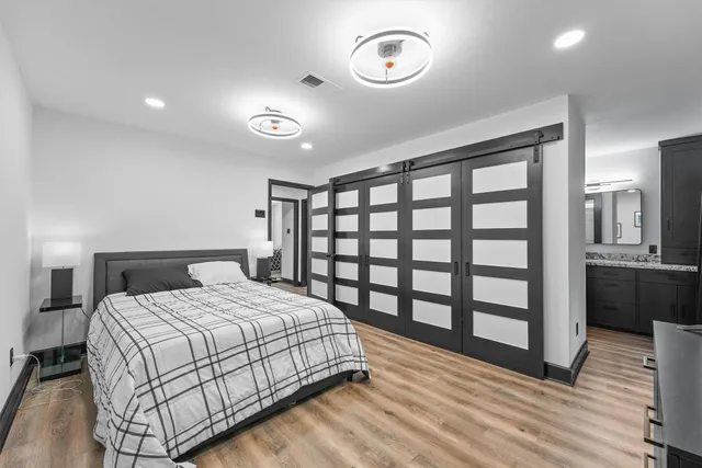 a bedroom with a large bed and a large window