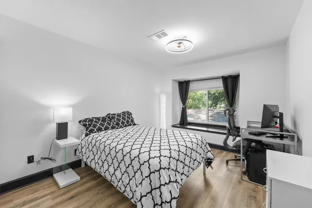 a bedroom with a bed and a window