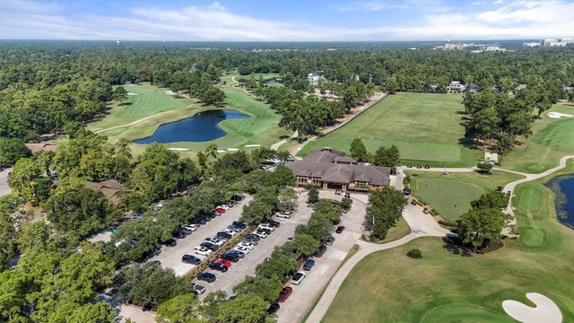 an aerial view of residential houses with outdoor space and trees