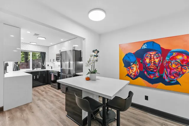 a view of a dining room with furniture and chandelier
