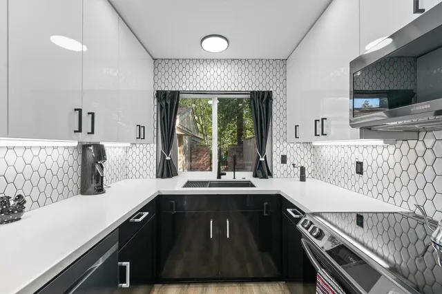 a kitchen with a sink stove and microwave