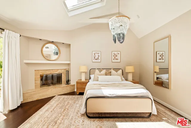 a bedroom with a bed and a fireplace