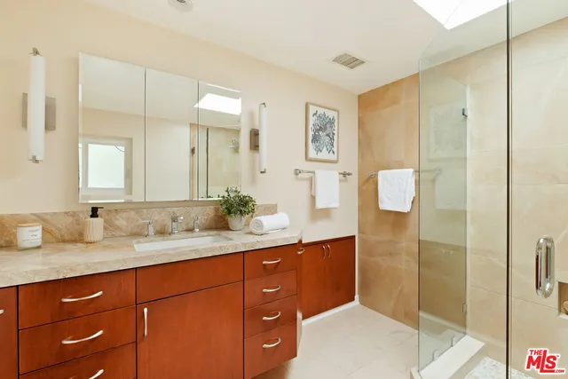 a bathroom with a granite countertop sink mirror and double
