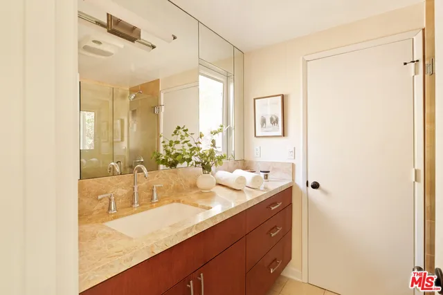 a bathroom with a granite countertop sink mirror and a