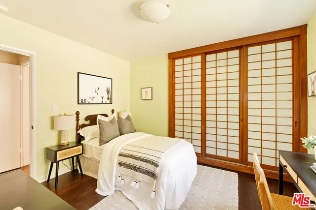 a bedroom with a bed and a large window