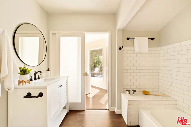 a bathroom with a sink a toilet and a mirror