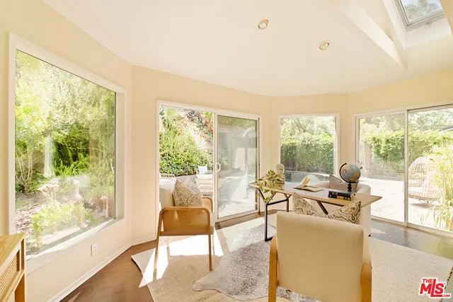 a living room with furniture and floor to ceiling windows