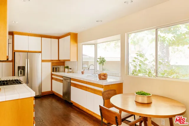 a kitchen with a sink a counter and a dining table