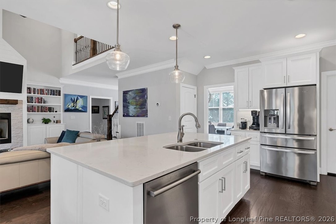 10 Heatherspring Way Spring Lake, NC 28390 - Photo 23 of 48 a kitchen with stainless steel appliances kitchen island a refrigerator sink and cabinets