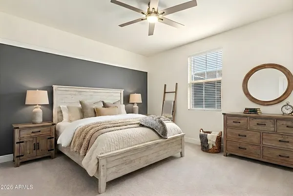 a bedroom with a bed a dresser and a mirror
