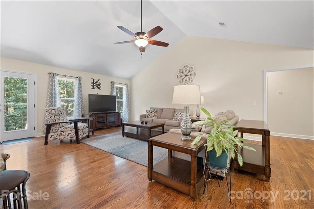 769 Shady Forest Road Clover, SC 29710 - Photo 12 of 36 a living room with furniture a flat screen tv and a large window