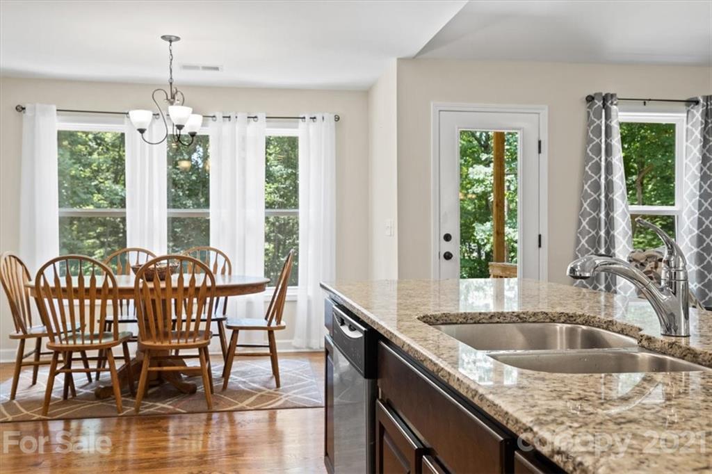 769 Shady Forest Road Clover, SC 29710 - Photo 16 of 36 a kitchen with granite countertop a table chairs and a sink