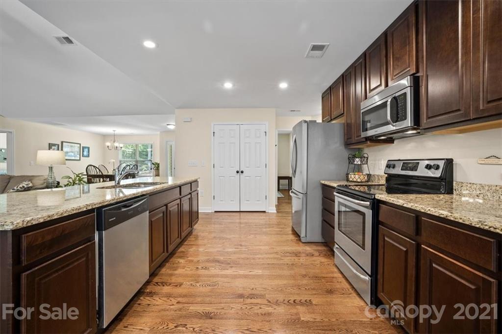 769 Shady Forest Road Clover, SC 29710 - Photo 19 of 36 a large kitchen with stainless steel appliances granite countertop a refrigerator a stove top oven a sink and dishwasher