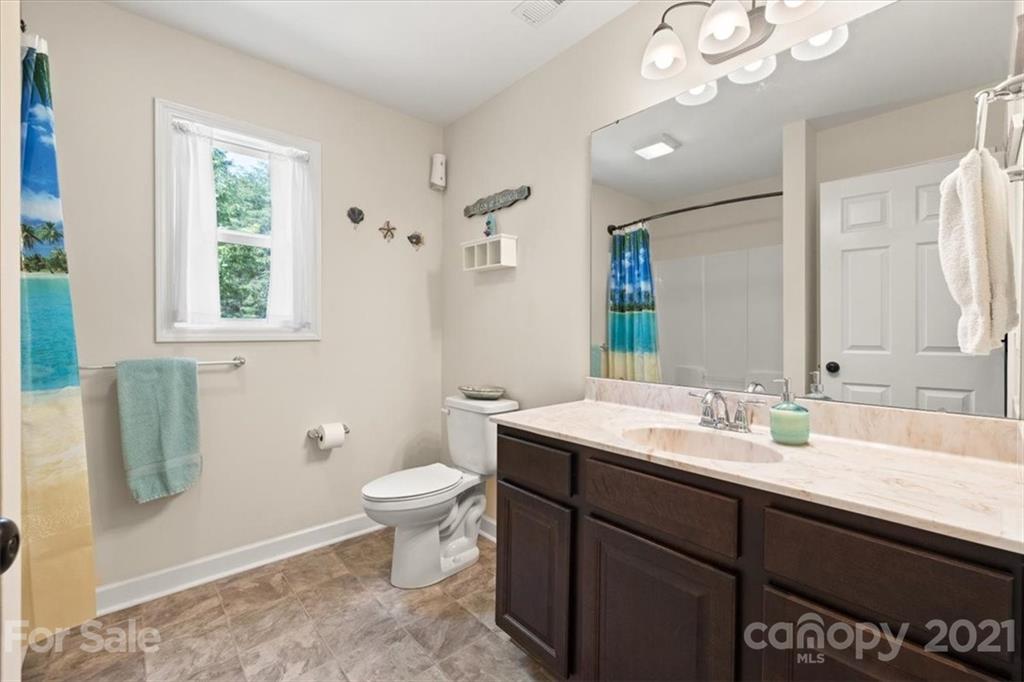 769 Shady Forest Road Clover, SC 29710 - Photo 22 of 36 a bathroom with a sink a toilet and a mirror