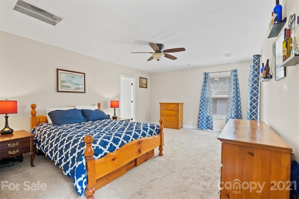 769 Shady Forest Road Clover, SC 29710 - Photo 23 of 36 a bedroom with a bed and a dresser with rug