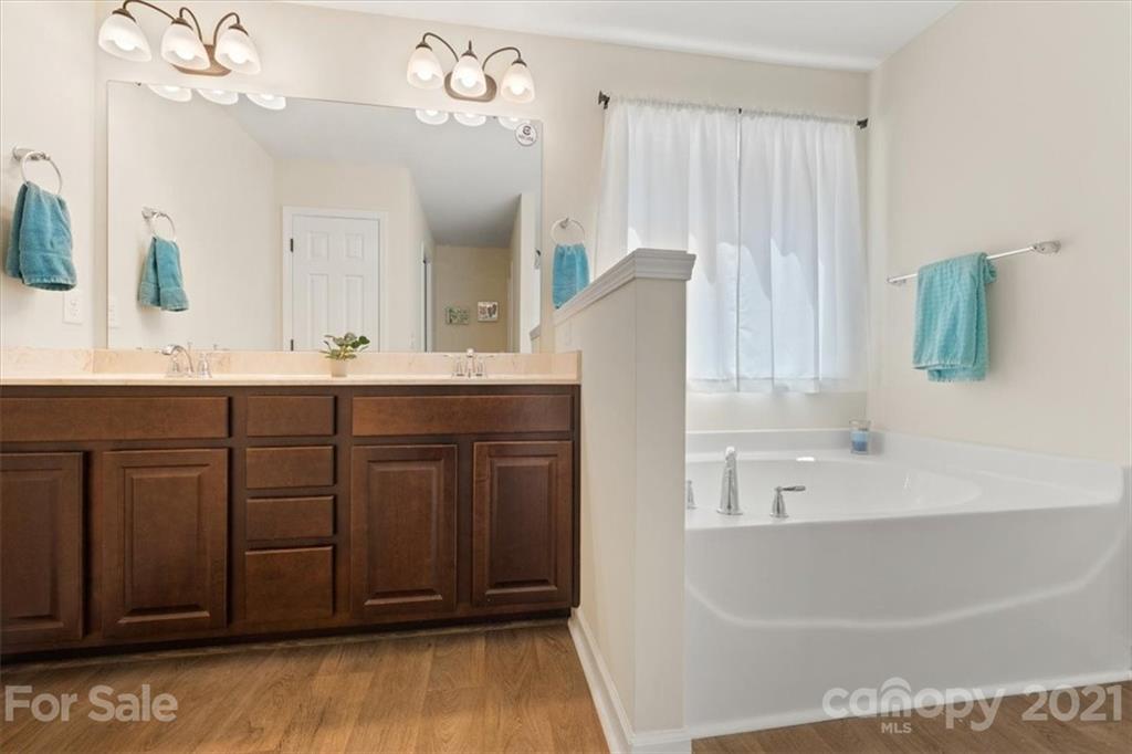 769 Shady Forest Road Clover, SC 29710 - Photo 26 of 36 a bathroom with a sink a mirror and a bathtub