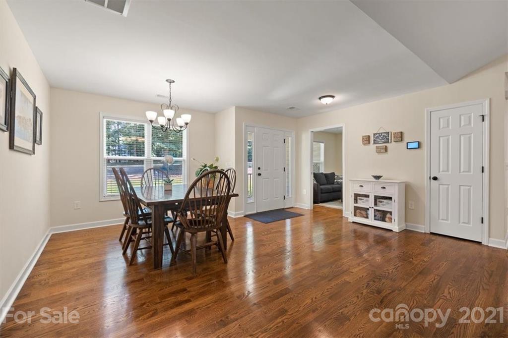 769 Shady Forest Road Clover, SC 29710 - Photo 10 of 36 a view of a dining room with furniture and wooden floor