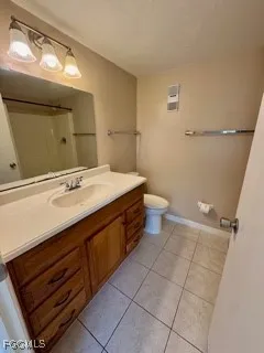 a spacious bathroom with a sink a toilet and a mirror