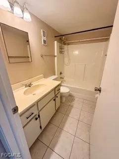 a bathroom with a sink mirror vanity and toilet