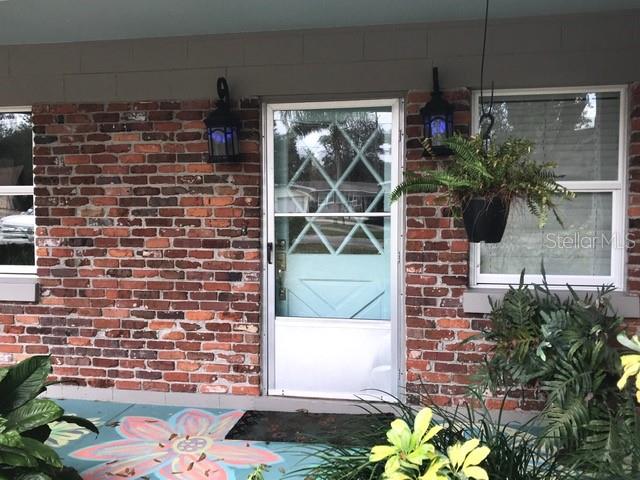 a view of front door and potted plants